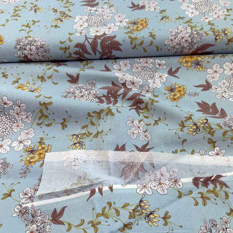 Fast bomuld med spredte blomster