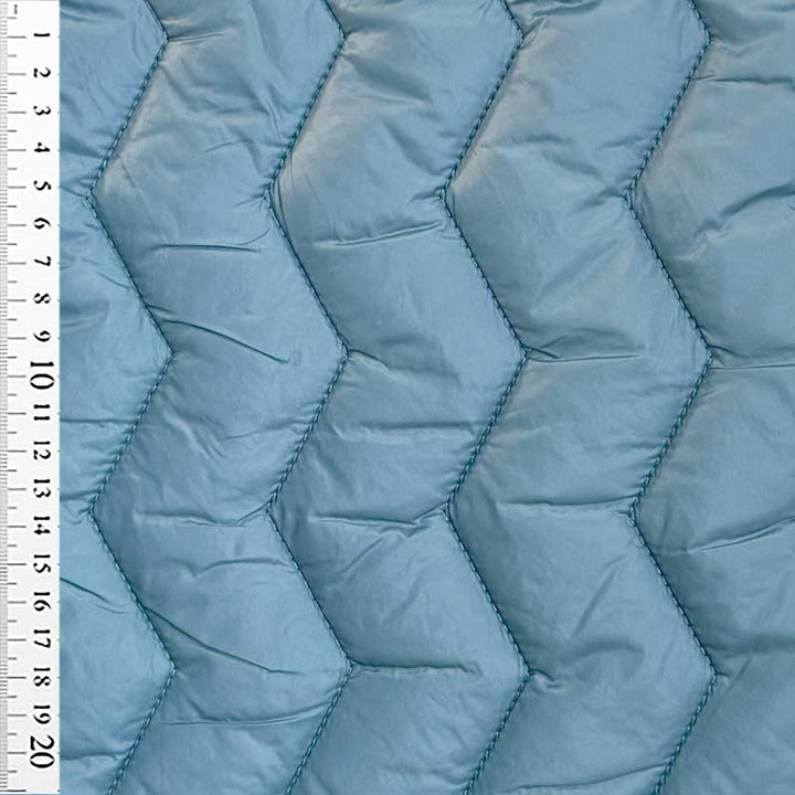 Quilt i zig-zag baner i lys petrol
