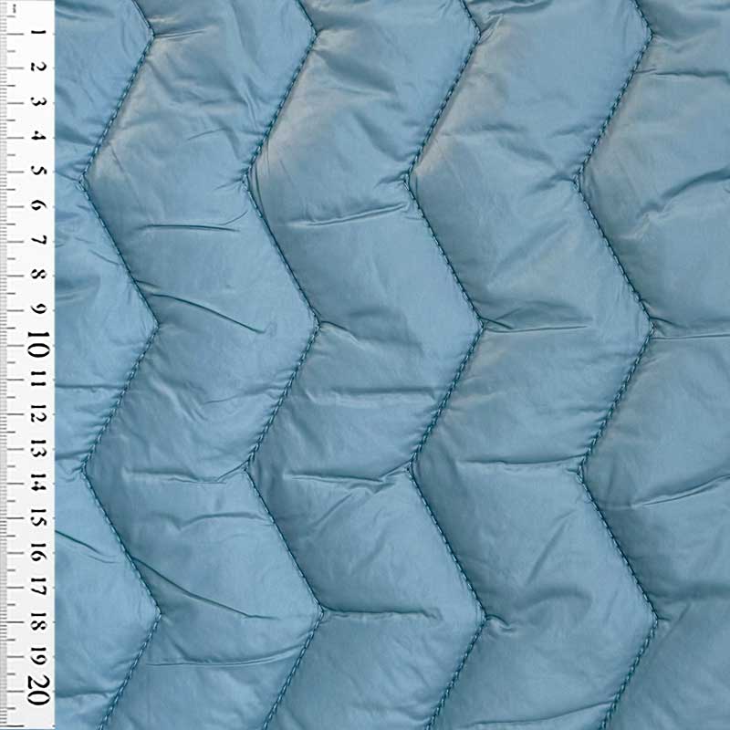 Quilt i zig-zag baner i lys petrol