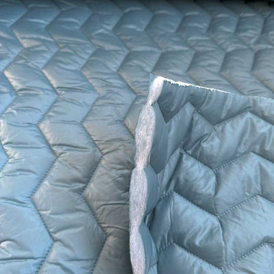Quilt i zig-zag baner i lys petrol