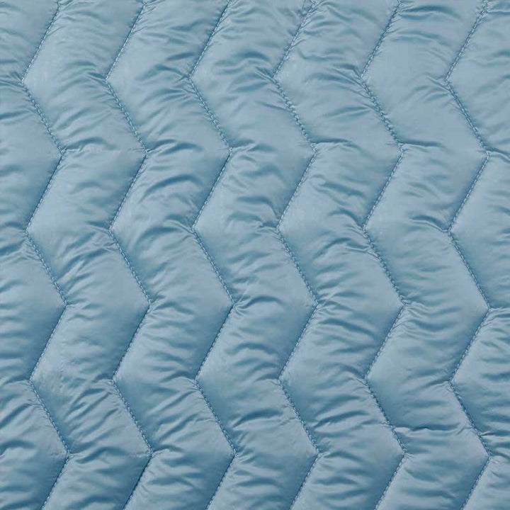 Quilt i zig-zag baner i lys petrol