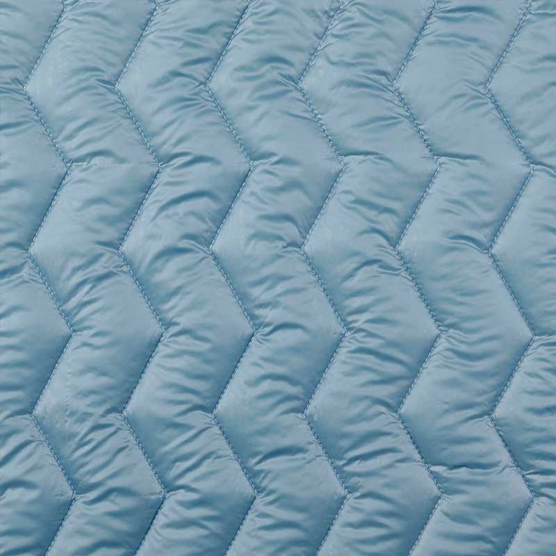 Quilt i zig-zag baner i lys petrol
