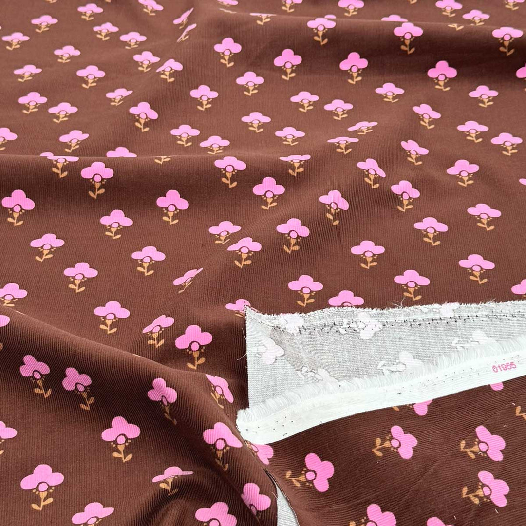 Babyfløjl med grafisk blomsterlogo i brun