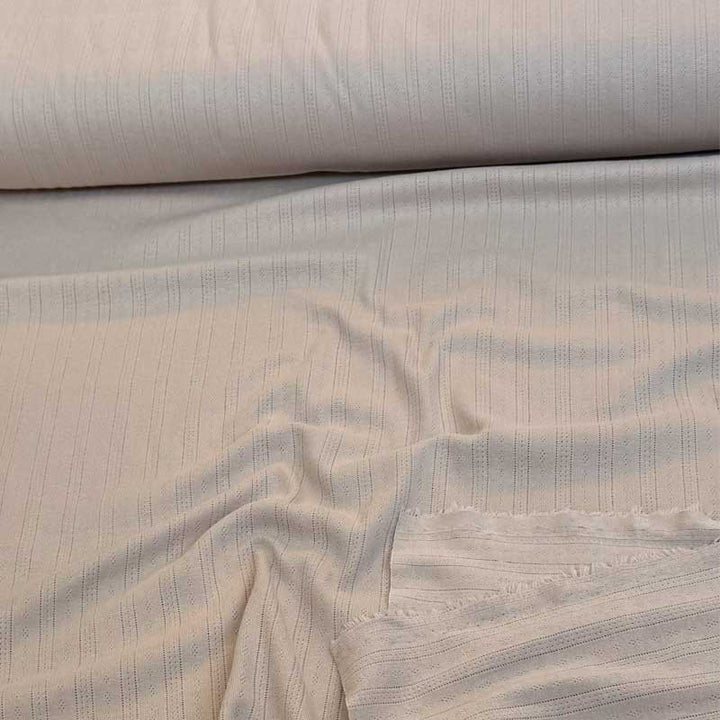 Ensfarvet beige bomuldsjersey med hulmønster