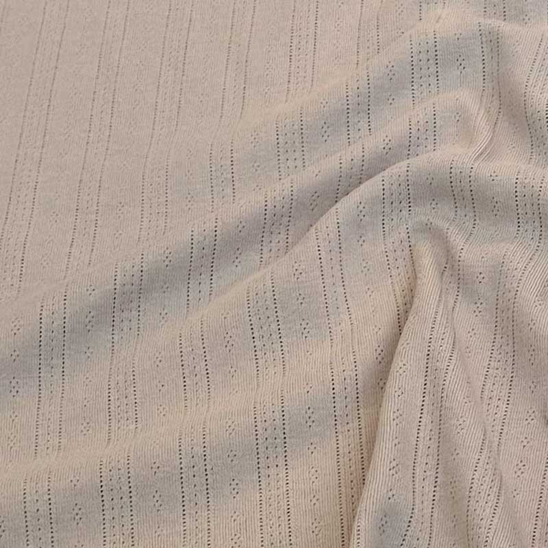 Ensfarvet beige bomuldsjersey med hulmønster