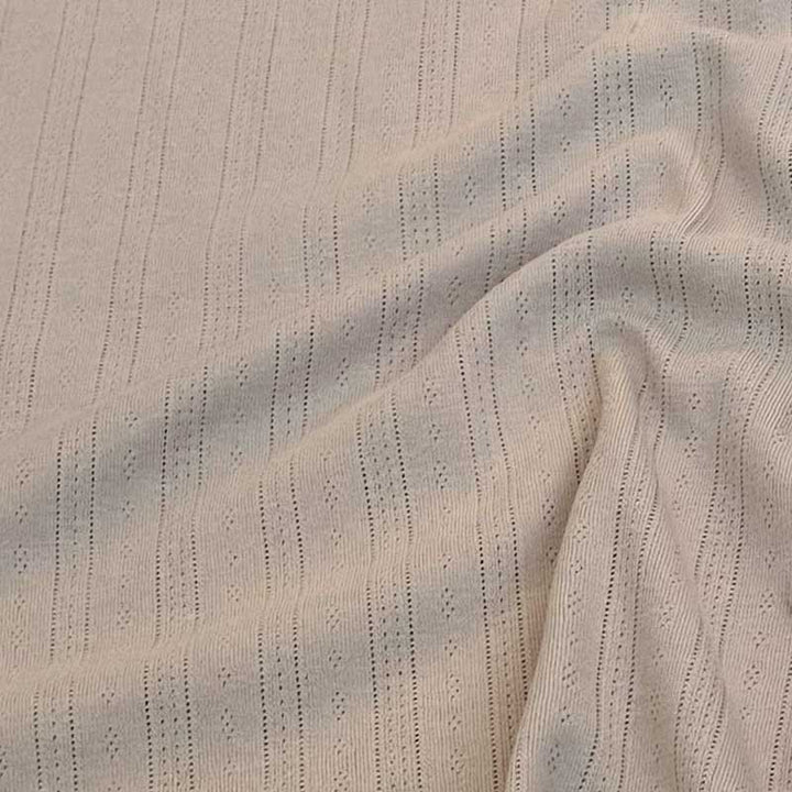 Ensfarvet beige bomuldsjersey med hulmønster