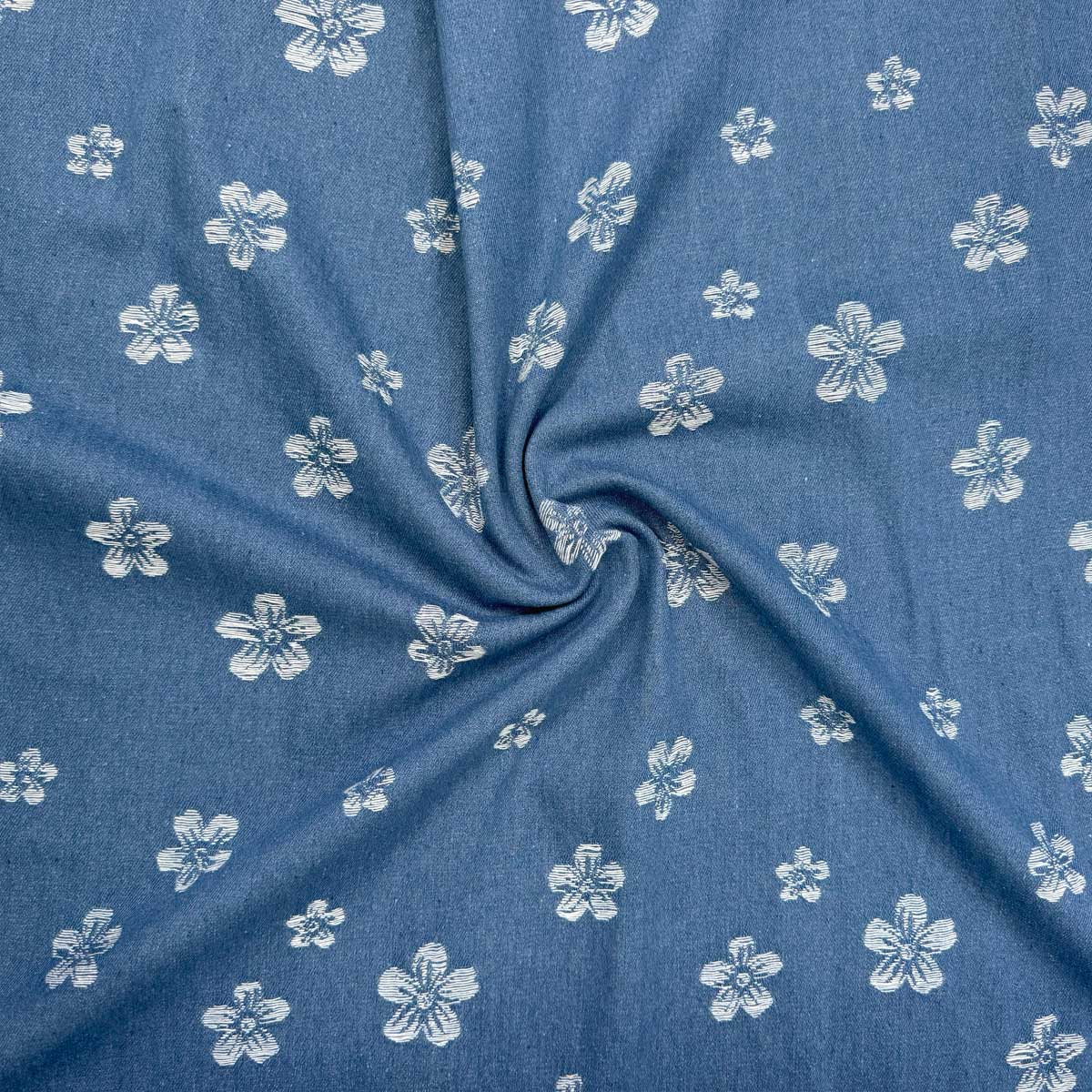 Denim med vævede blomster på jeansblå bund