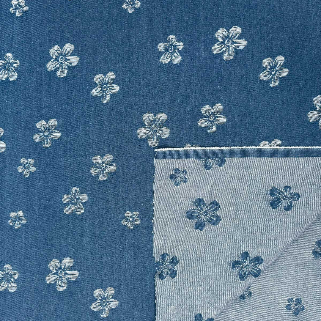 Denim med vævede blomster på jeansblå bund