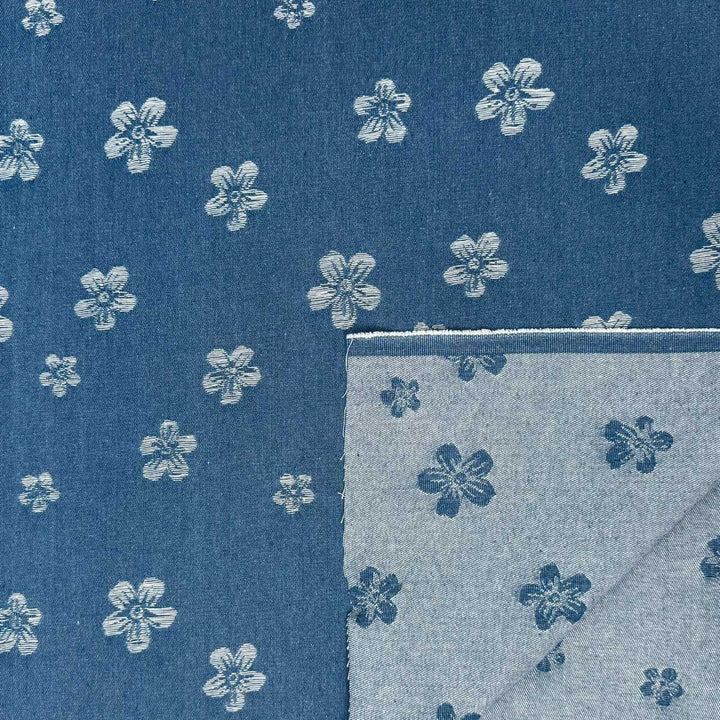 Denim med vævede blomster på jeansblå bund