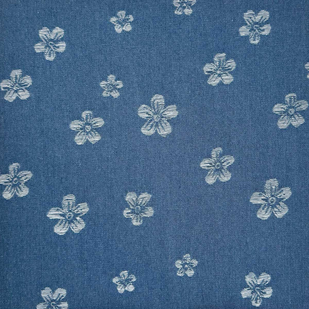 Denim med vævede blomster på jeansblå bund
