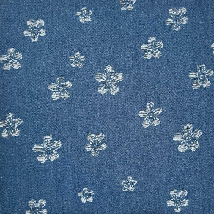 Denim med vævede blomster på jeansblå bund