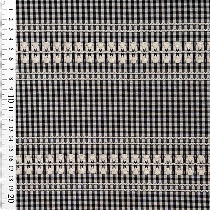 Vævet bomuld med tern og broderi i sort