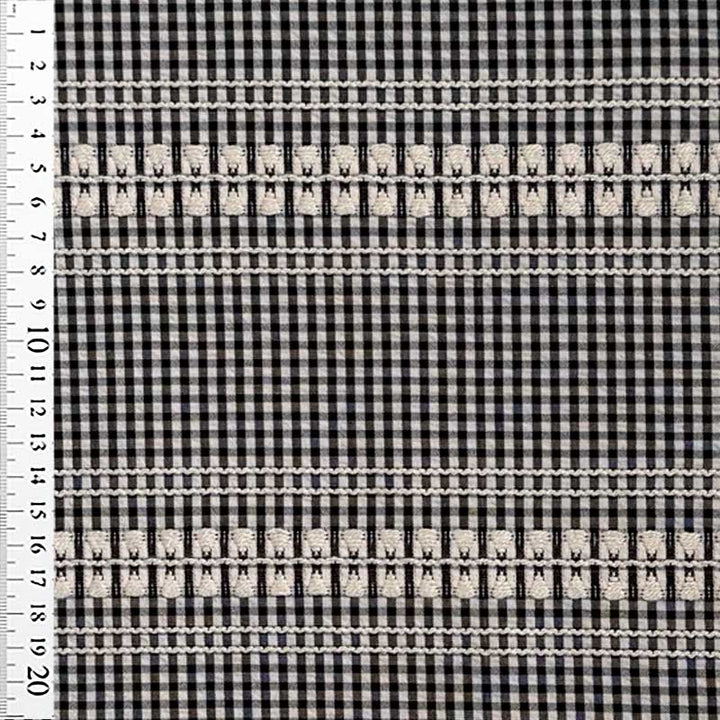 Vævet bomuld med tern og broderi i sort